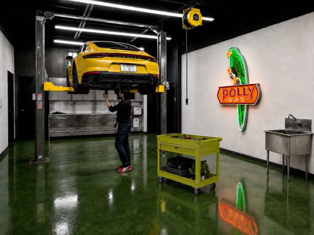 A ceiling-mounted retractable cord reel disappears when not in use and drops exactly where power is needed. In a designed garage, power infrastructure is planned before drywall, not added as an afterthought.

